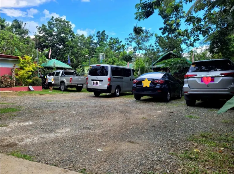 Gravel parking area with space for several cars