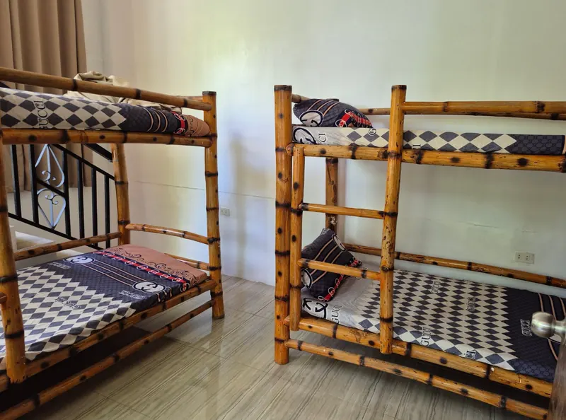 Air-conditioned farmhouse room with bamboo bunk beds