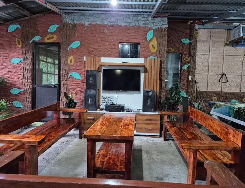 Videoke lounge with wooden benches and big TV